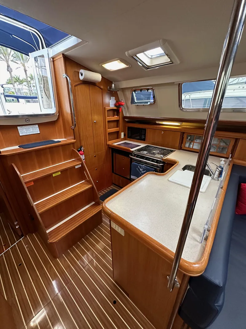 Slide: The Image of Interior of 2007 Hunter 44 Deck Salon yacht with wooden cabinetry and modern kitchen amenities. - 41