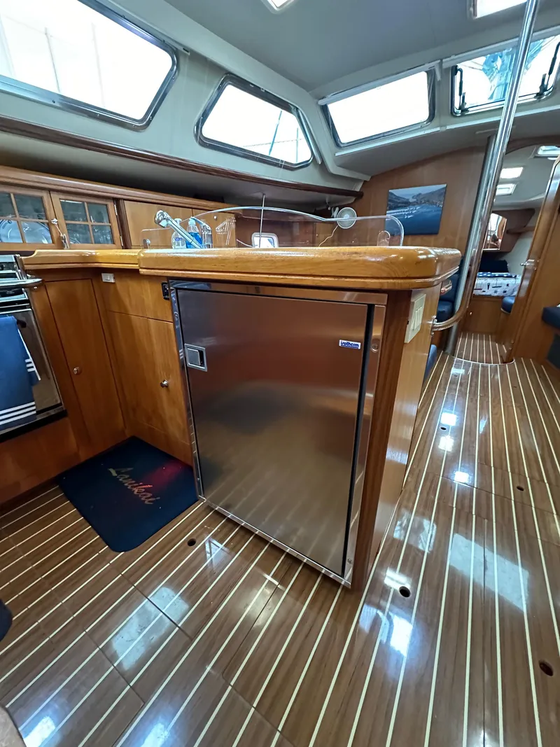 Slide: The Image of 2007 Hunter 44 Deck Salon interior with wood flooring and stainless steel appliances. - 43