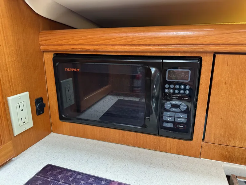 Slide: The Image of Microwave in 2007 Hunter 44 Deck Salon yacht kitchen with wood cabinetry. - 45
