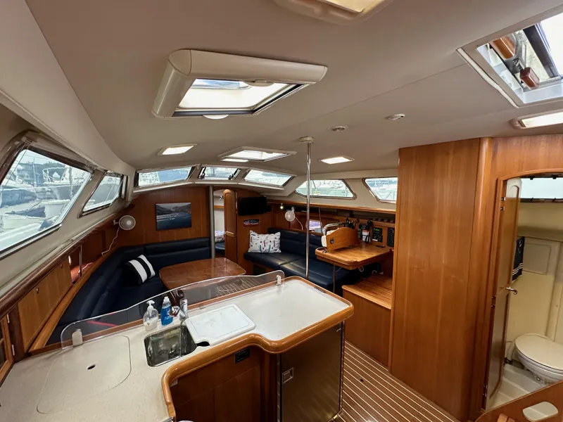 Slide: The Image of Interior of 2007 Hunter 44 Deck Salon yacht with spacious seating and wooden finishes. - 48