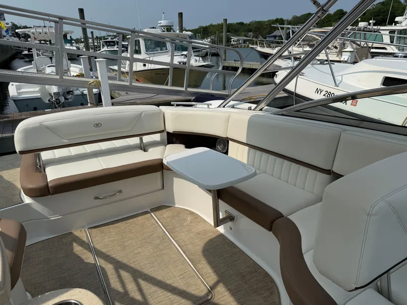 Slide: The Image of Luxurious seating area on a 2015 Cobalt 302 boat docked at a marina. - 11