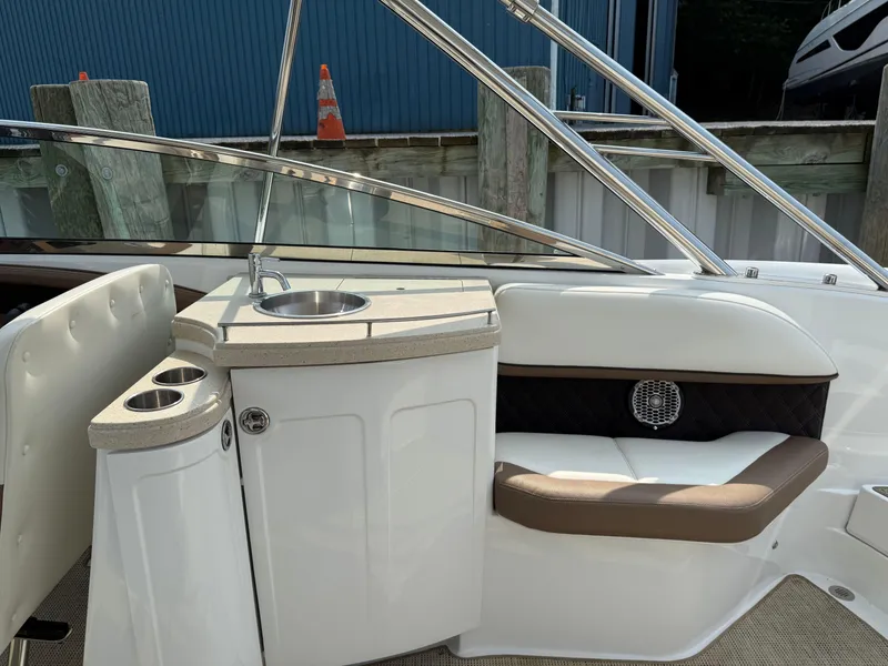 Slide: The Image of 2015 Cobalt 302 boat interior with sink and seating area. - 12