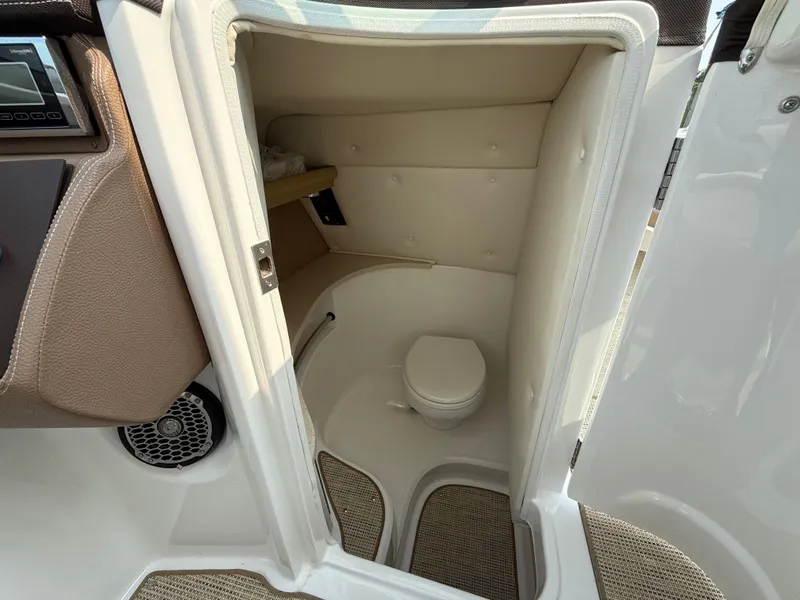 Slide: The Image of Interior of a 2015 Cobalt 302 boat showing a compact bathroom with a toilet. - 15