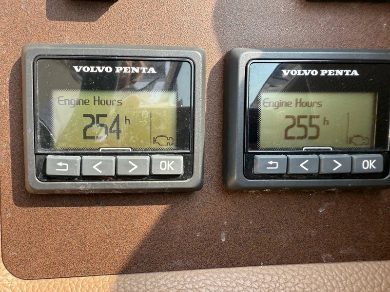 Slide: The Image of Volvo Penta engine hour meters showing 254 and 255 hours on a 2015 Cobalt 302. - 18