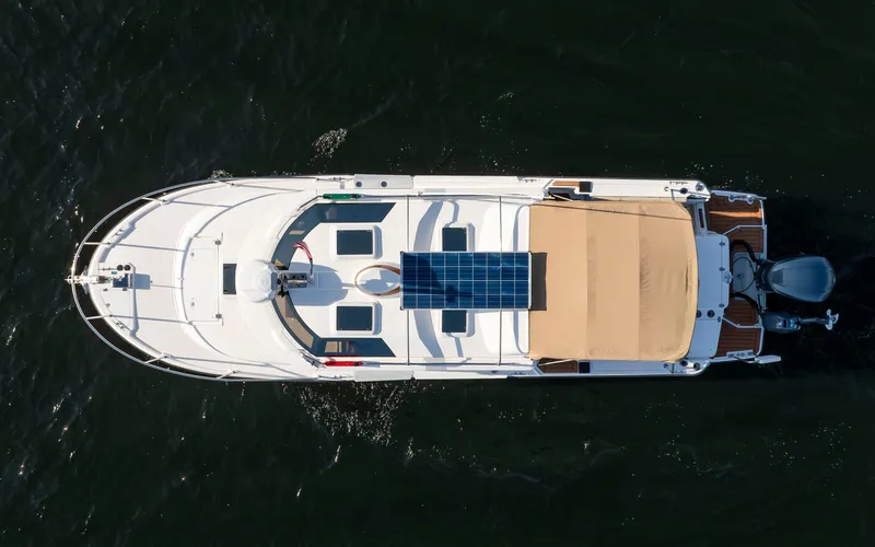 Slide: The Image of Overhead view of 2020 Ranger Tugs R-27 boat with solar panels on water. - 1