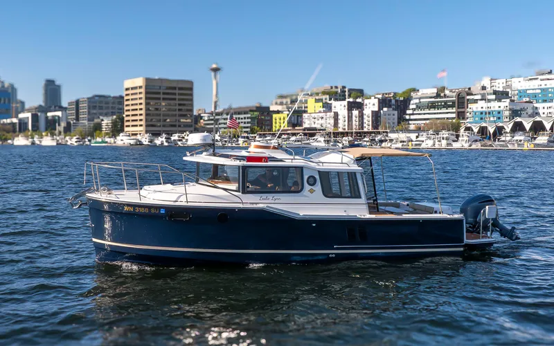Slide: The Image of 2020 Ranger Tugs R-27 boat on urban waterfront with city skyline. - 16