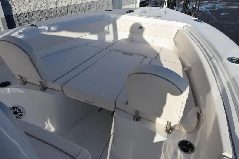 Slide: The Image of 2025 Sea Hunt Gamefish 25 boat interior with cushioned seating and cup holders. - 11
