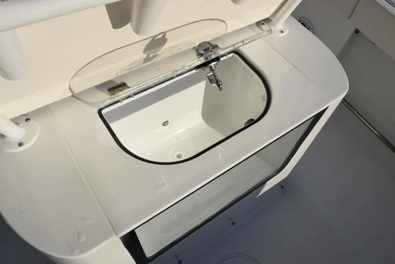 Slide: The Image of 2025 Sea Hunt Gamefish 25 boat livewell with transparent lid and faucet. - 16