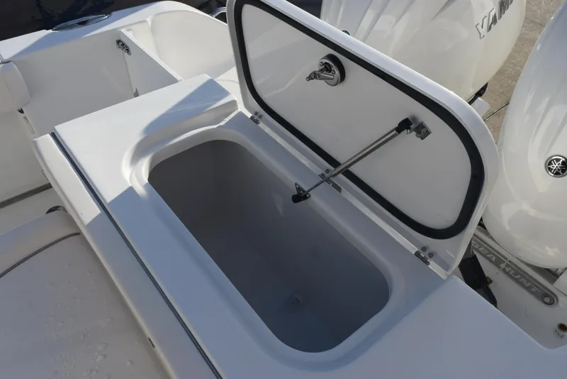 Slide: The Image of Open storage compartment on a 2025 Sea Hunt Gamefish 25 boat, showcasing interior space. - 18