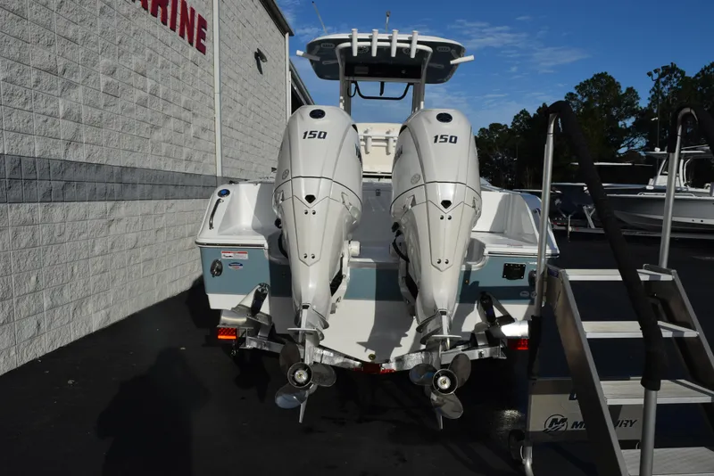 Slide: The Image of 2025 Sea Hunt Gamefish 25 boat with dual 150 horsepower engines, parked outdoors. - 4