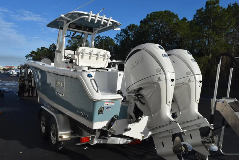 Slide: The Image of 2025 Sea Hunt Gamefish 25 boat with dual Yamaha engines on a trailer. - 5