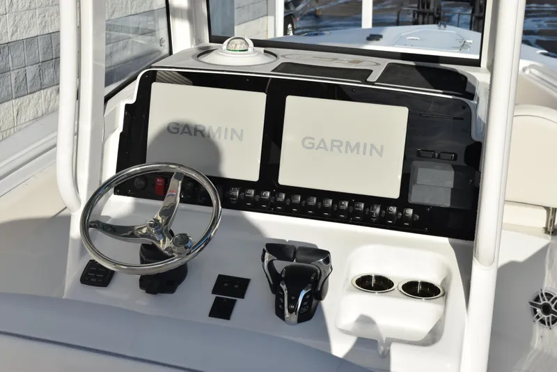 Slide: The Image of 2025 Sea Hunt Gamefish 25 dashboard with dual Garmin displays and steering wheel. - 8