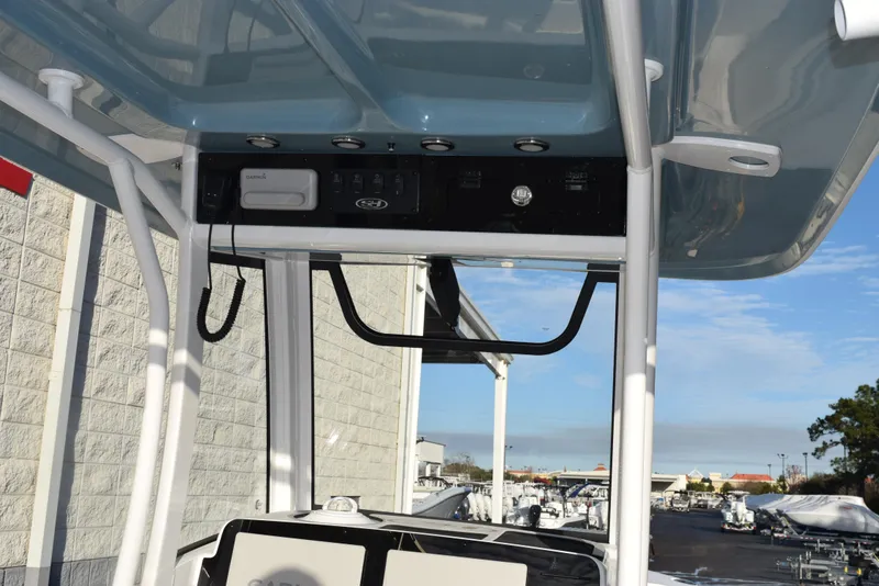Slide: The Image of 2025 Sea Hunt Gamefish 25 boat console with overhead electronics and controls. - 9