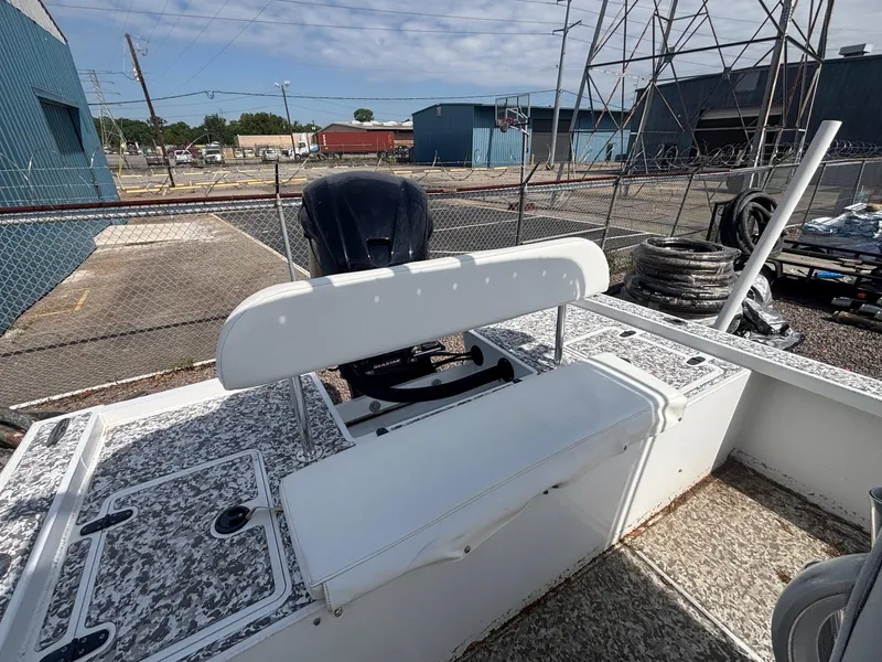 Slide: The Image of 2018 Cast & Blast 22 Kings Bay boat with outboard motor, docked in an industrial area. - 6