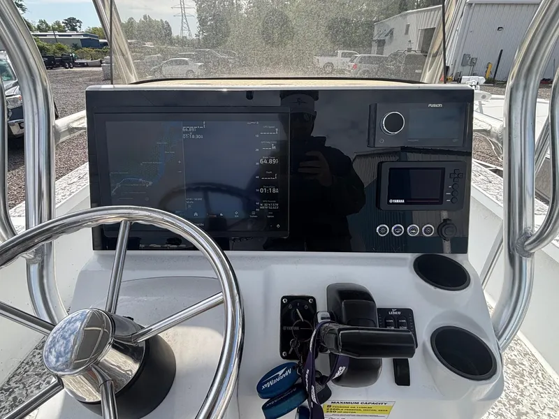Slide: The Image of 2018 Cast & Blast 22 Kings Bay boat dashboard with steering wheel and navigation controls. - 9