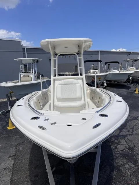 Slide: The Image of 2025 Key West 219 FS boat, white exterior, docked outdoors under clear blue sky. - 12