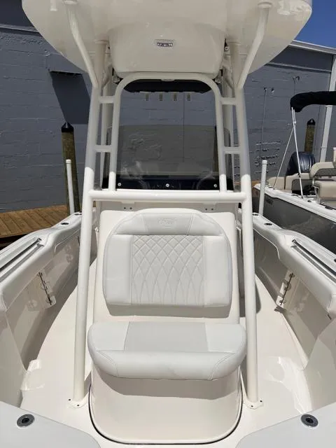 Slide: The Image of 2025 Key West 219 FS boat with white seating and T-top in a marina setting. - 14