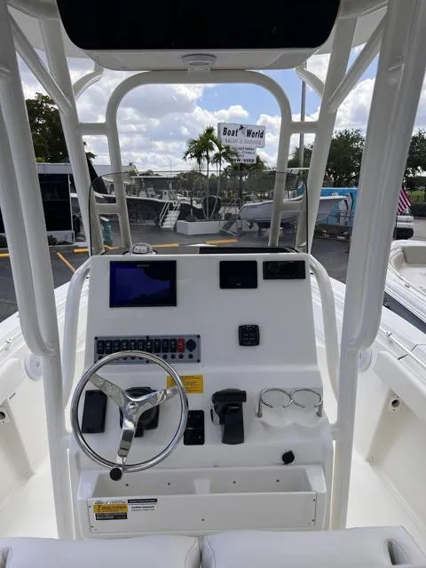 Slide: The Image of 2025 Key West 219 FS boat dashboard with steering wheel and control panel. - 16