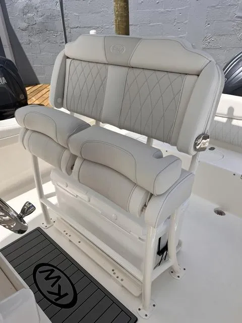 Slide: The Image of 2025 Key West 219 FS boat seating with cushioned backrest and armrests. - 18