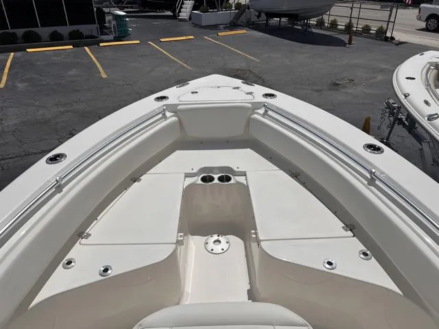 Slide: The Image of 2025 Key West 219 FS boat deck, featuring spacious seating and cup holders. - 20