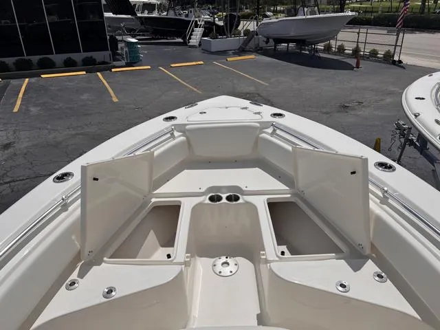 Slide: The Image of 2025 Key West 219 FS boat interior with storage compartments and cup holders. - 21