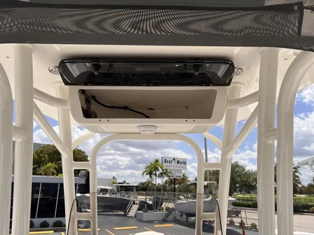 Slide: The Image of 2025 Key West 219 FS boat interior with overhead console, viewed at a marina. - 24