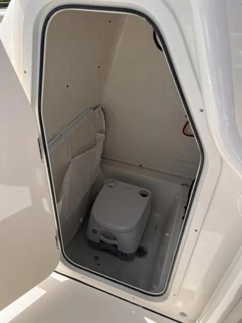 Slide: The Image of 2025 Key West 219 FS boat interior with compact marine toilet. - 25