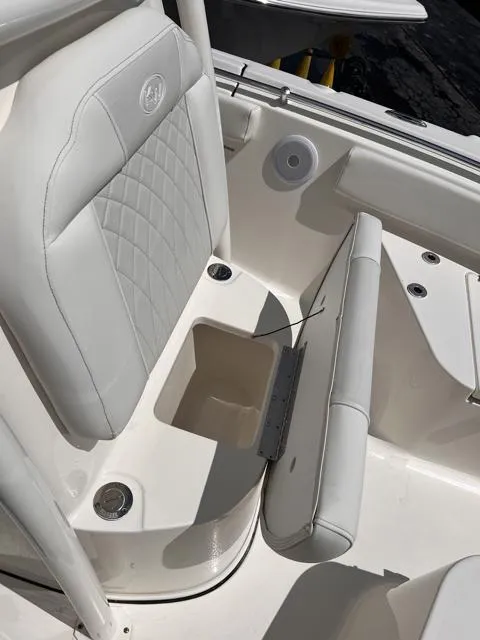 Slide: The Image of 2025 Key West 219 FS boat seat with storage compartment, white upholstery, and quilted design. - 26