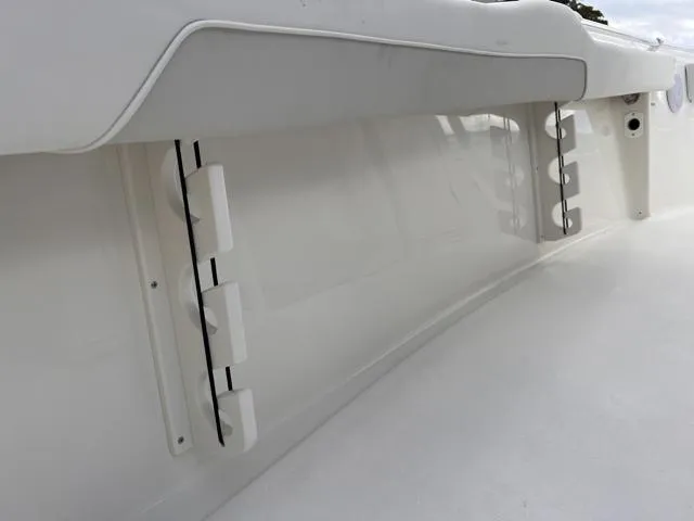 Slide: The Image of 2025 Key West 219 FS boat interior, featuring sleek white seating and rod holders. - 31
