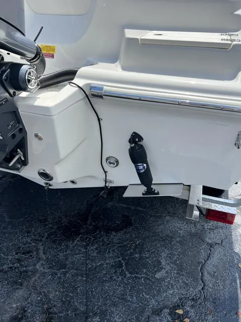 Slide: The Image of 2025 Key West 219 FS boat stern with motor and trim tab details. - 36