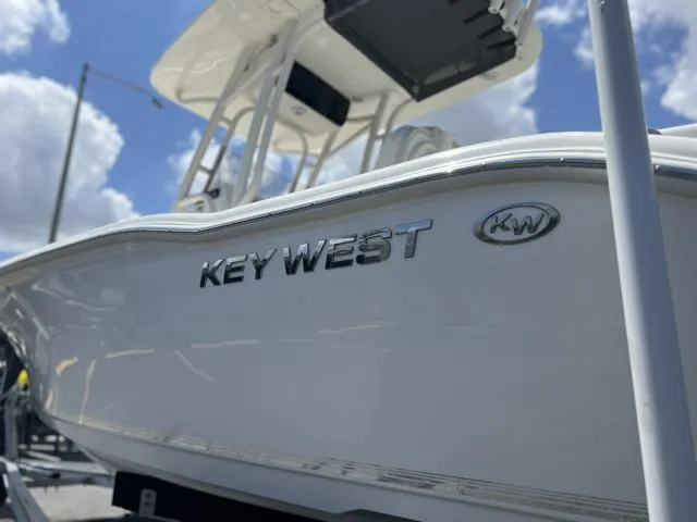 Slide: The Image of 2025 Key West 219 FS boat, sleek design under a bright blue sky. - 37