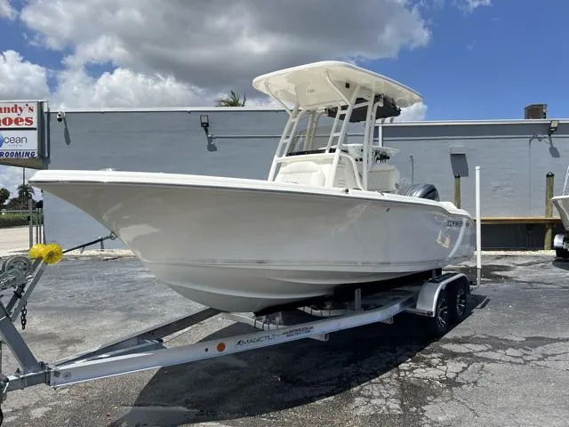 Slide: The Image of 2025 Key West 219 FS boat on trailer, parked outdoors under cloudy sky. - 9