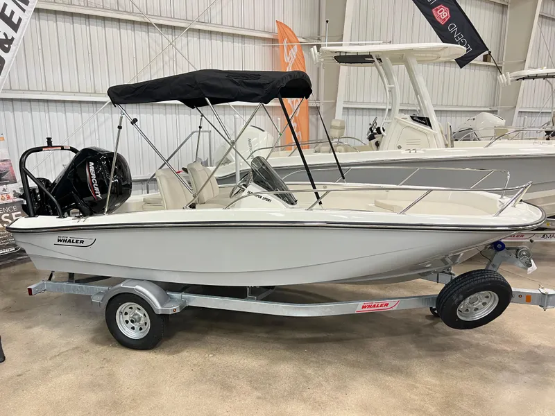 Slide: The Image of 2025 Boston Whaler 160 Super Sport boat on trailer in showroom. - 0