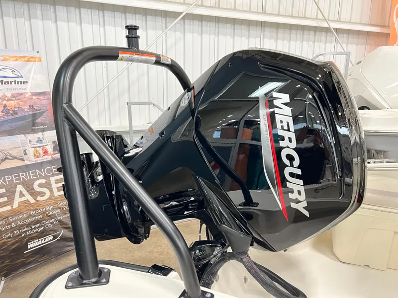 Slide: The Image of 2025 Boston Whaler 160 Super Sport with Mercury outboard engine in showroom. - 2