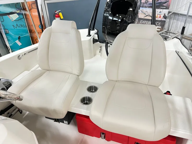 Slide: The Image of 2025 Boston Whaler 160 Super Sport interior with beige seats and cup holders. - 5