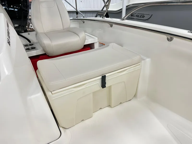 Slide: The Image of 2025 Boston Whaler 160 Super Sport interior with cushioned seating and storage. - 6