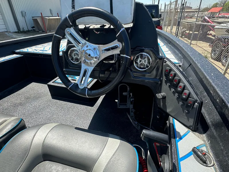 Slide: The Image of 2021 Xpress X19 Pro boat cockpit with steering wheel and control panel. - 13