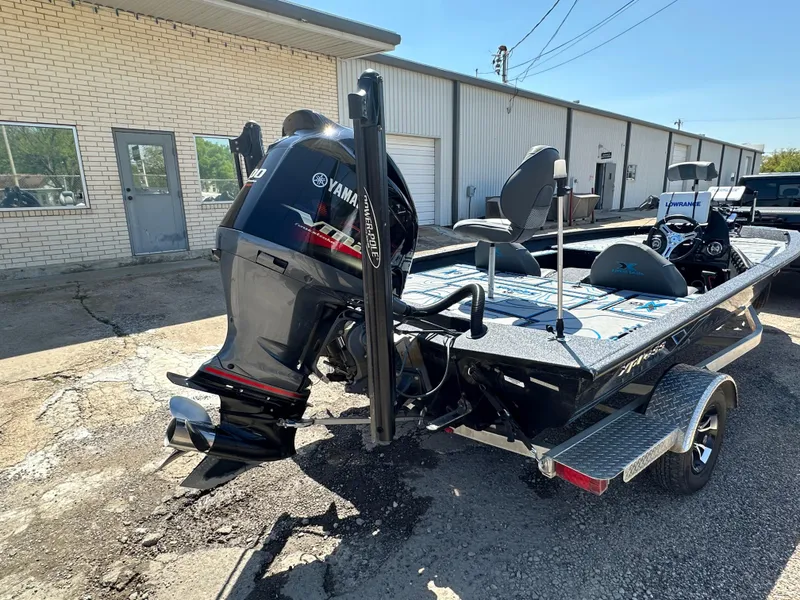 Slide: The Image of 2021 Xpress X19 Pro boat with Yamaha engine parked outside a building. - 3