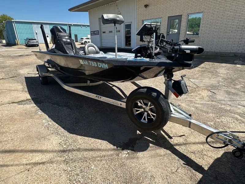 Slide: The Image of 2021 Xpress X19 Pro boat on trailer, parked outside a building. - 6