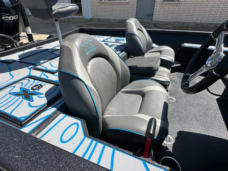 Slide: The Image of 2021 Xpress X19 Pro boat interior with gray and blue seating. - 9
