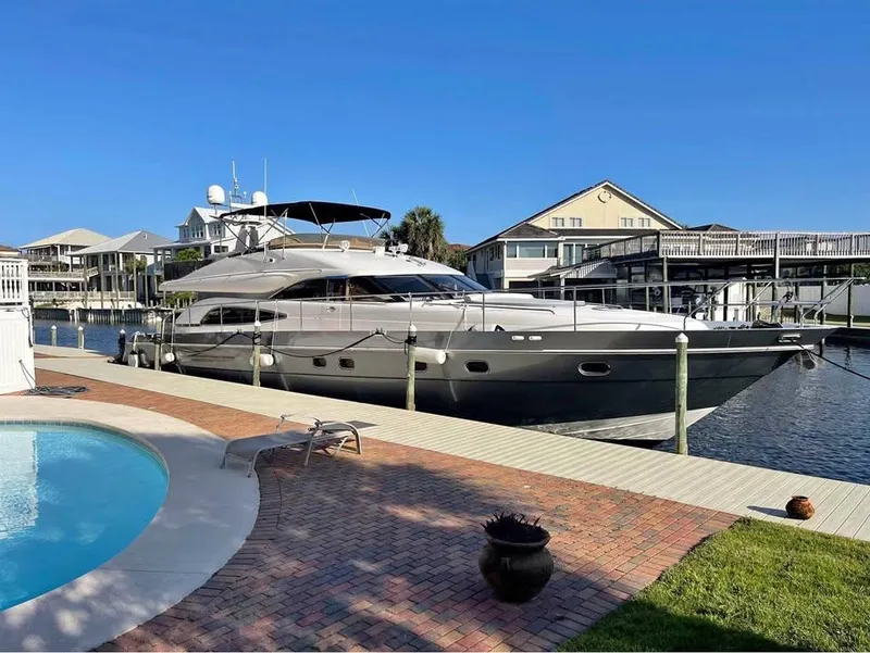 The Image of Luxury 2003 Viking Princess 65 yacht docked by a poolside, under clear blue skies. - 0