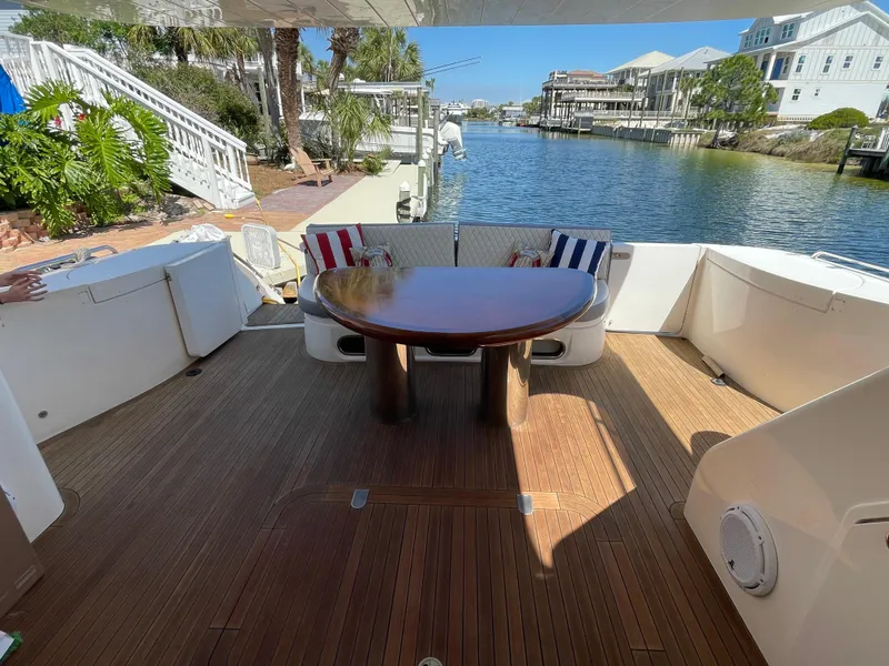 Slide: The Image of Luxurious 2003 Viking Princess 65 yacht deck with wooden flooring and elegant seating. - 11