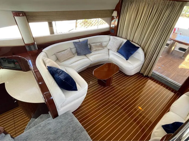 Slide: The Image of Luxurious 2003 Viking Princess 65 yacht interior with elegant seating and wooden flooring. - 19