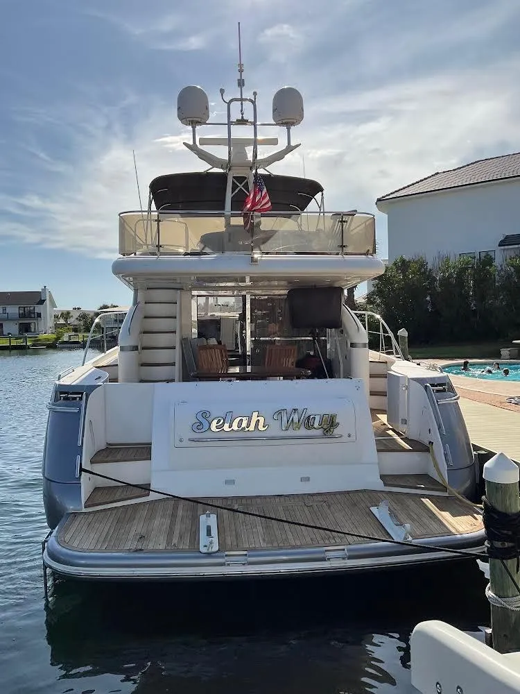 Slide: The Image of Luxury 2003 Viking Princess 65 yacht docked at marina, rear view. - 2