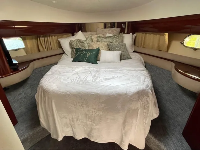 Slide: The Image of Luxurious bedroom interior of 2003 Viking Princess 65 yacht with elegant bedding and wood accents. - 24