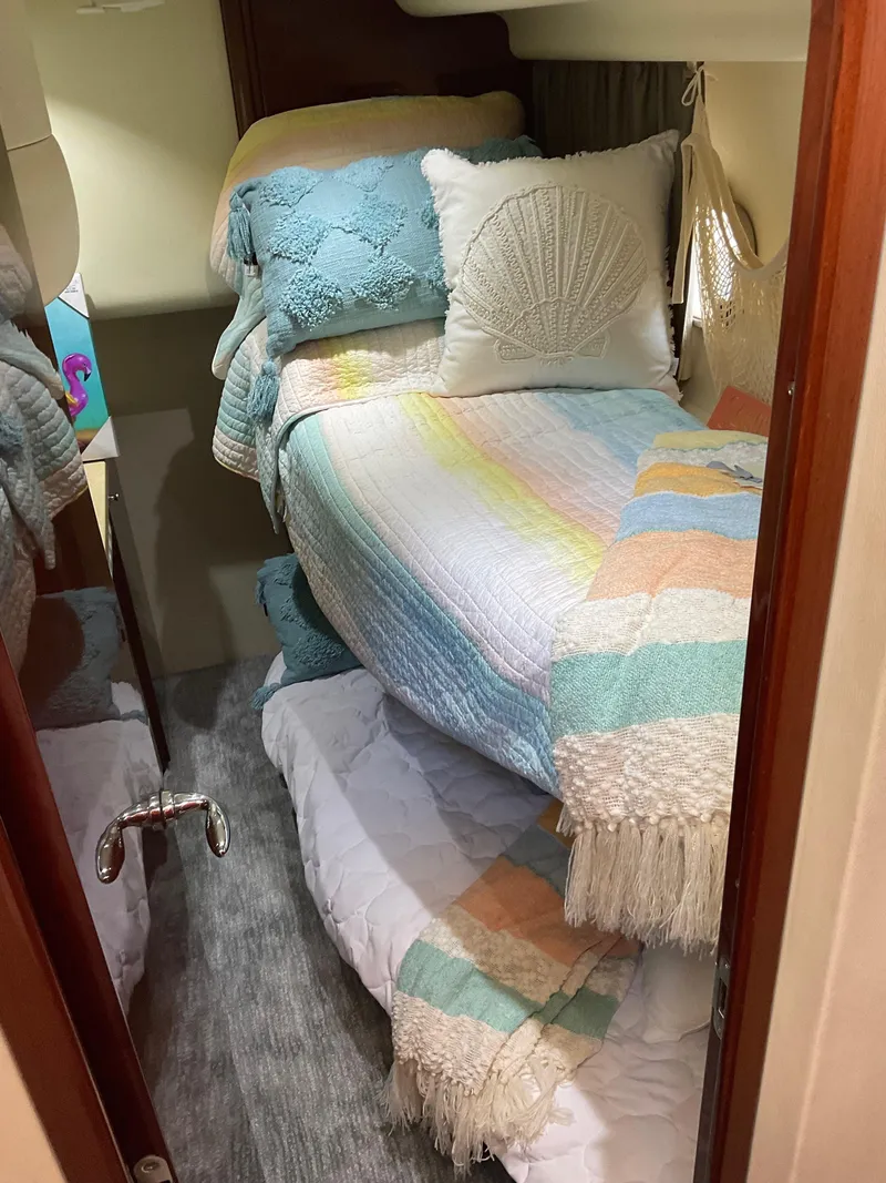 Slide: The Image of Cozy cabin interior of 2003 Viking Princess 65 yacht with colorful bedding and decor. - 27