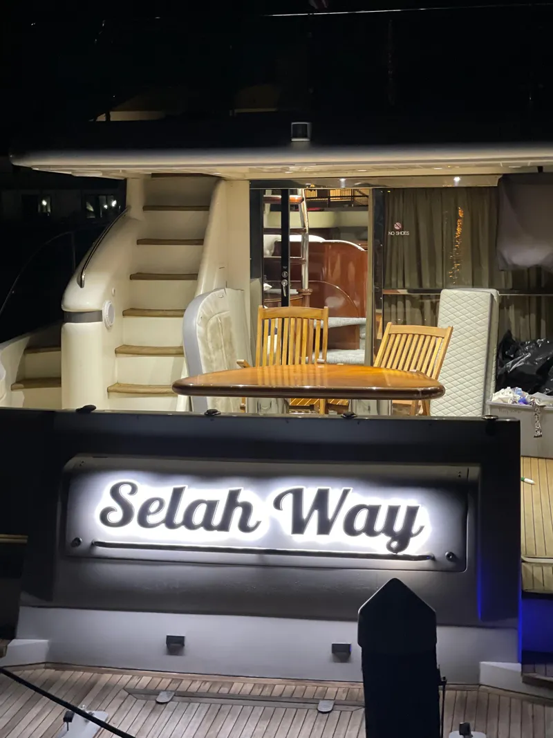 Slide: The Image of 2003 Viking Princess 65 yacht with illuminated "Selah Way" sign and elegant outdoor seating. - 5