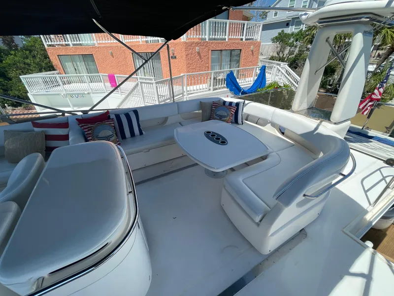 Slide: The Image of Luxurious 2003 Viking Princess 65 yacht deck with white seating and table. - 7
