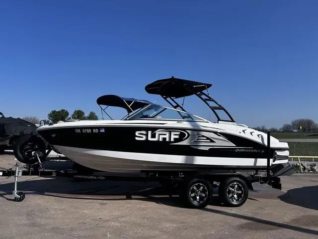 Slide: The Image of 2020 Chaparral 21 Surf boat on trailer under clear blue sky. - 1