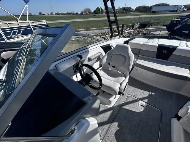 Slide: The Image of 2020 Chaparral 21 Surf boat interior with steering wheel and seating area. - 10